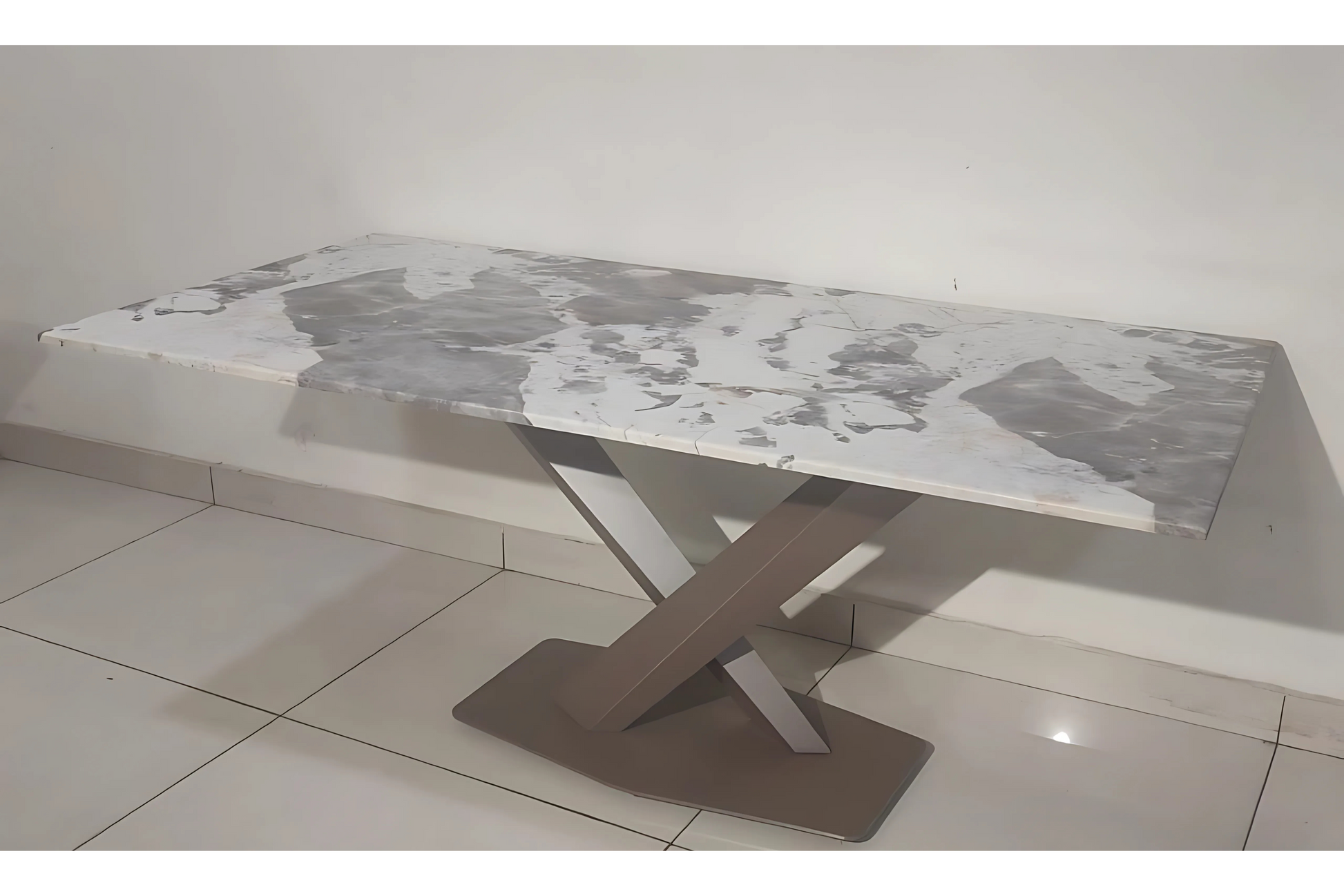 Modern X-base dining table with grey-white marble top and sculptural taupe metal pedestal