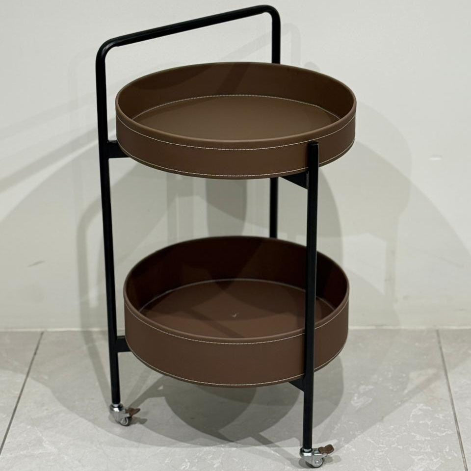 Two-tier side table with brown trays and black metal frame on a light gray floor.
