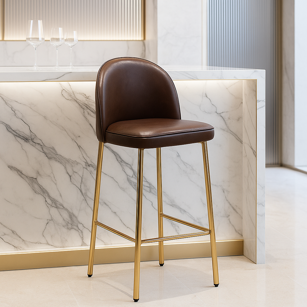 Brown bar stool with gold legs against a marble wall.