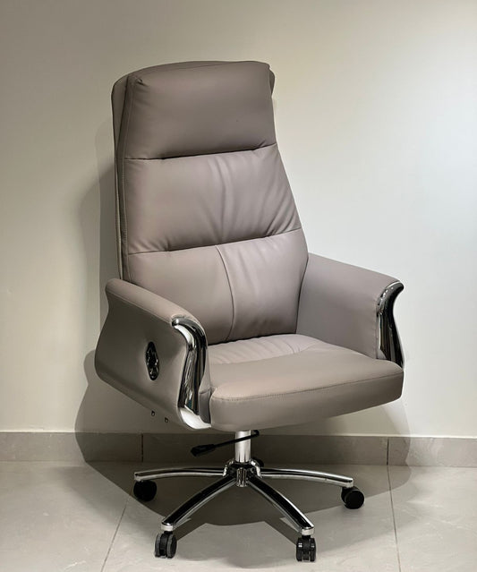 Grey high-back executive office revolving chair with chrome armrests and cushioned seat