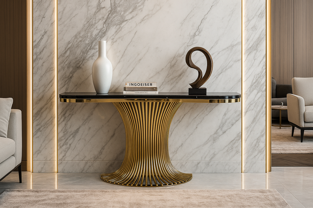 Decorative table with gold base and black top against a marble wall.