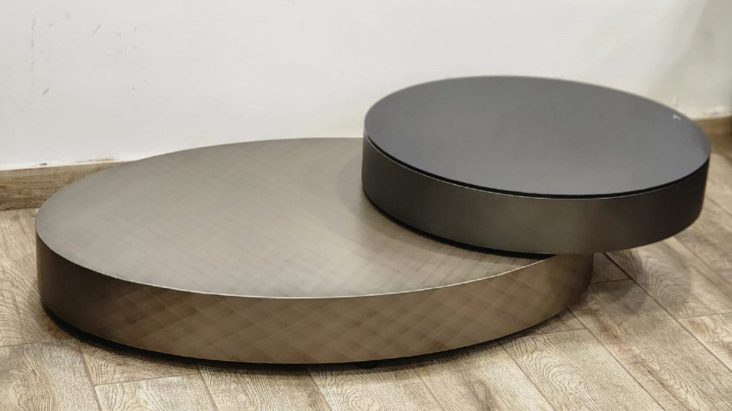 Luxury sculptural center table with bronze oval base and offset matte black round top