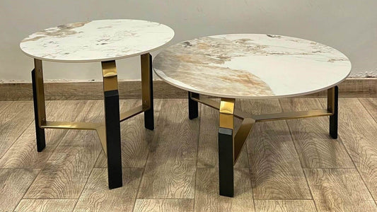 Dual round marble center table set with gold-black legs and natural veining in modern setting