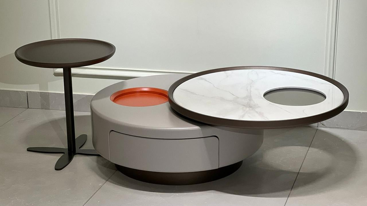 Modular round center coffee table with rotating marble top, storage base, and sculptural side pedestal