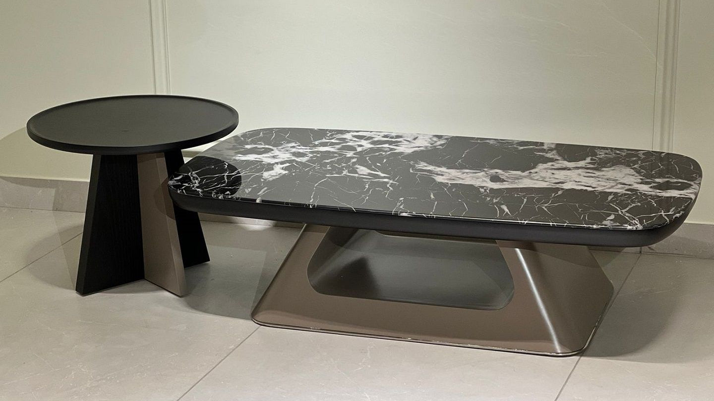 Modern marble center table set with black veined top, sculptural base, and round matte black side table