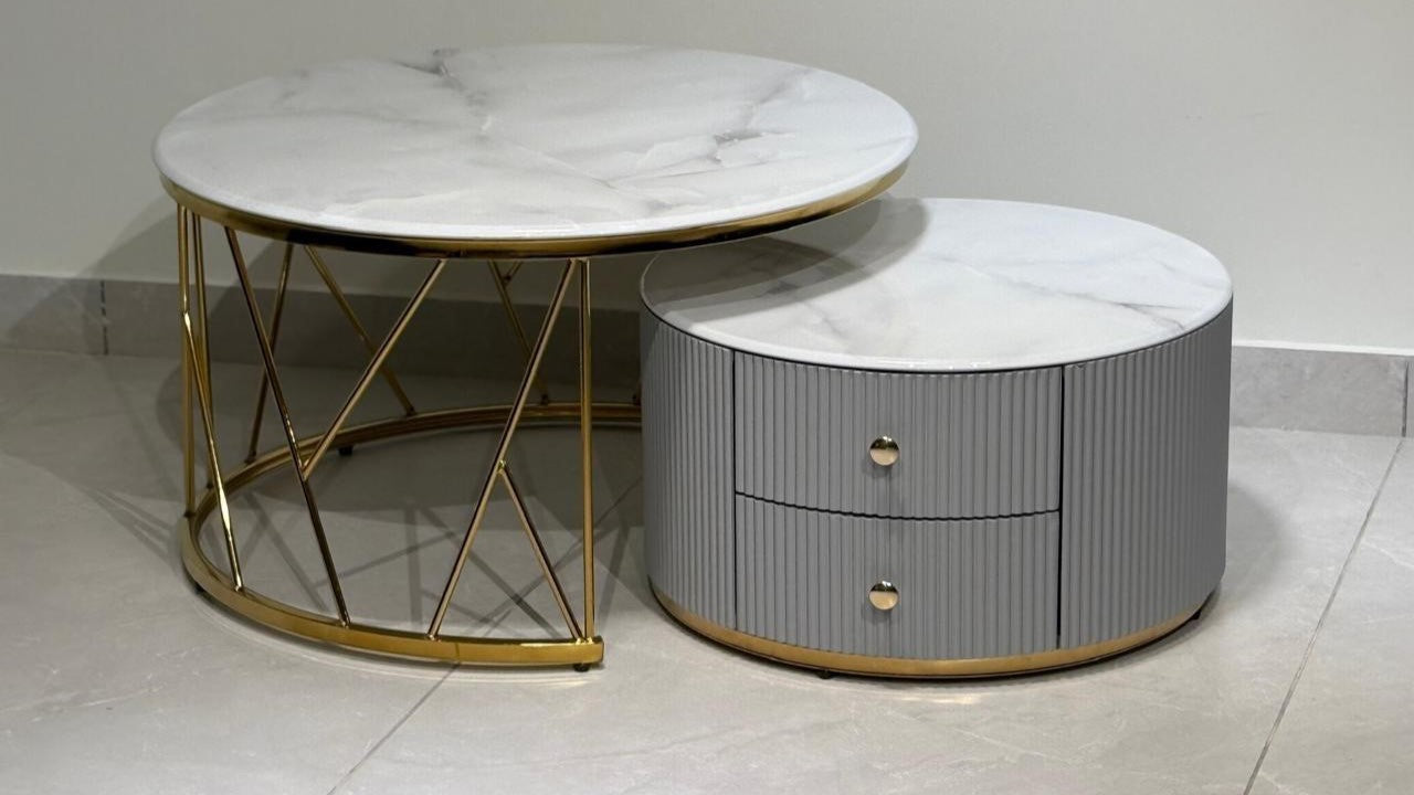 Luxury round marble center coffee table duo with gold base and fluted grey storage unit


