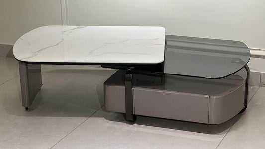 Dual-layer center table with white marble-effect top, smoked glass surface, and taupe base with hidden storage