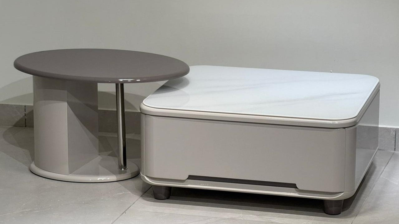 Modern square coffee table with marble top and matching round side table in neutral tones