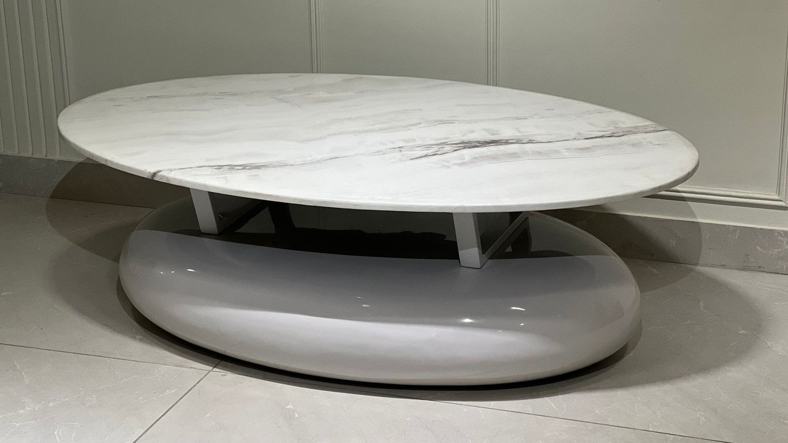 "Luxury oval white marble coffee table with sleek glossy base for modern interiors.
"