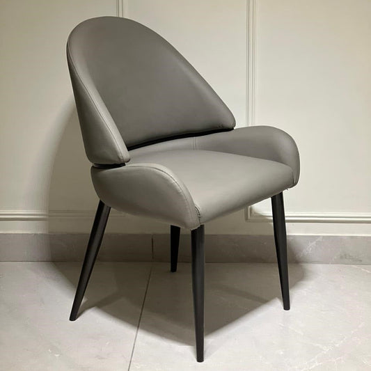 Dark grey luxury dining chair with arched backrest and black tapered legs