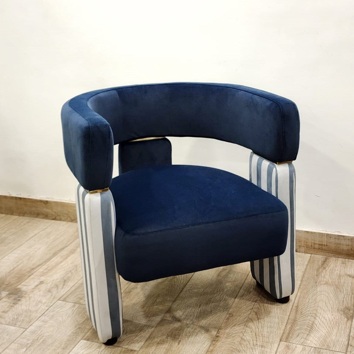 Blue velvet accent chair with striped legs in grey and white