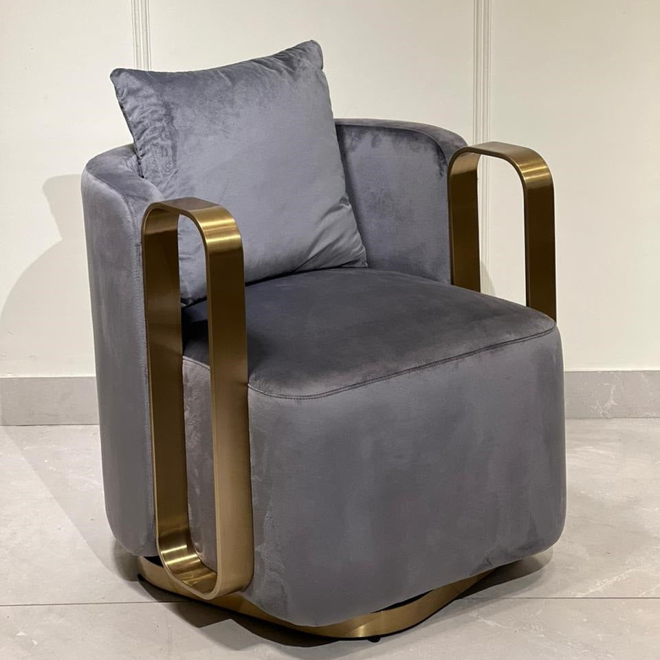 Gray leisure chair with gold armrests on a light background