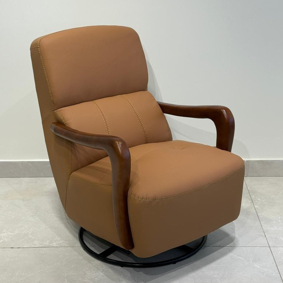 Tan rocking chair with wooden armrests on a light gray floor and white wall background.