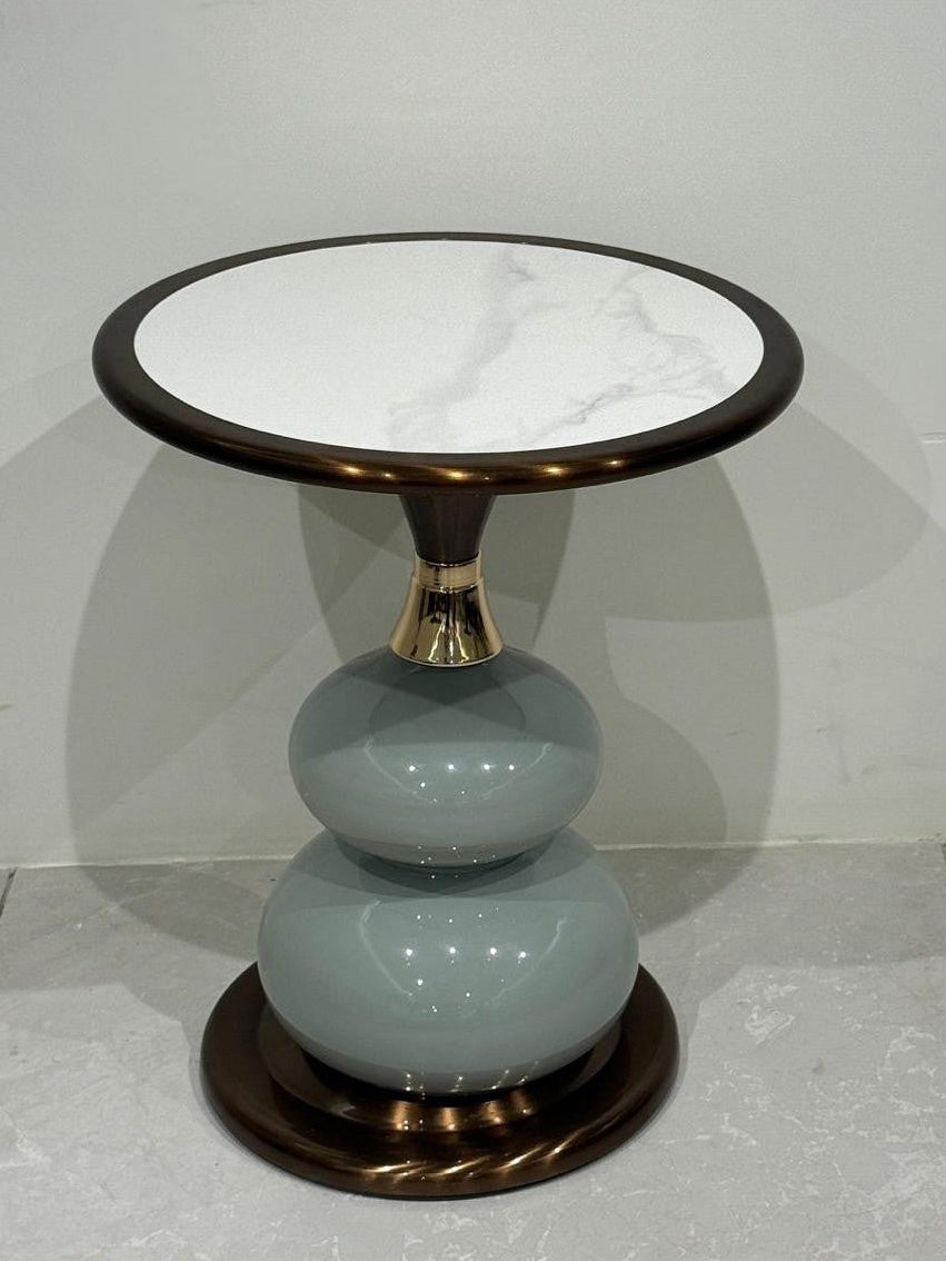 Side table with marble top and ceramic base on a gray background