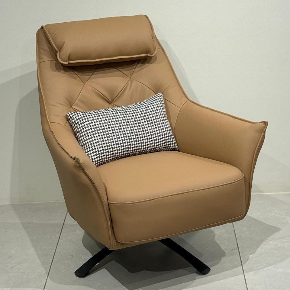 Tan leisure chair with a pillow on a light gray floor and white wall