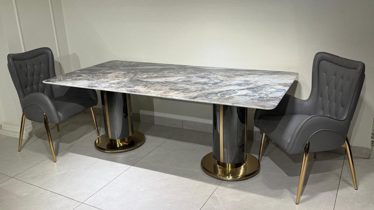 Dining set with marble table and gray chairs on a tiled floor. 