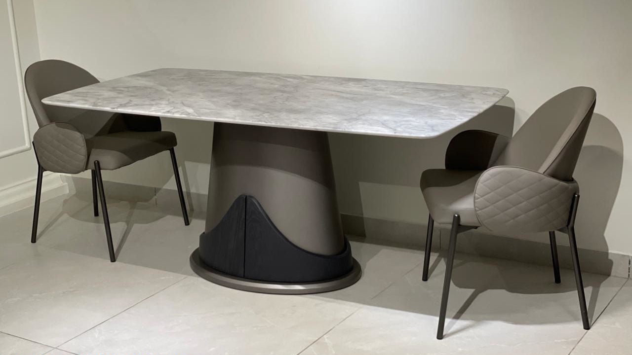 Dining table set with four chairs in a room setting, featuring product codes