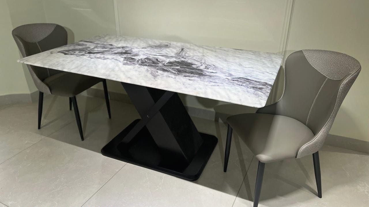 Dining table set with marble top and gray chairs on a light floor