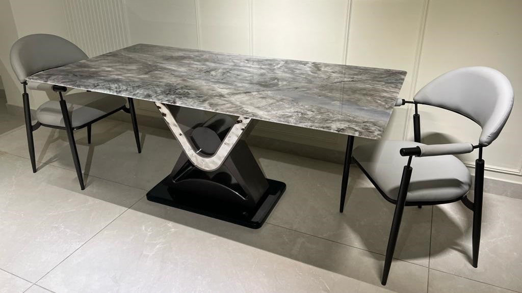 Dining table and chairs set with marble-like surface and gray color on a neutral background 
