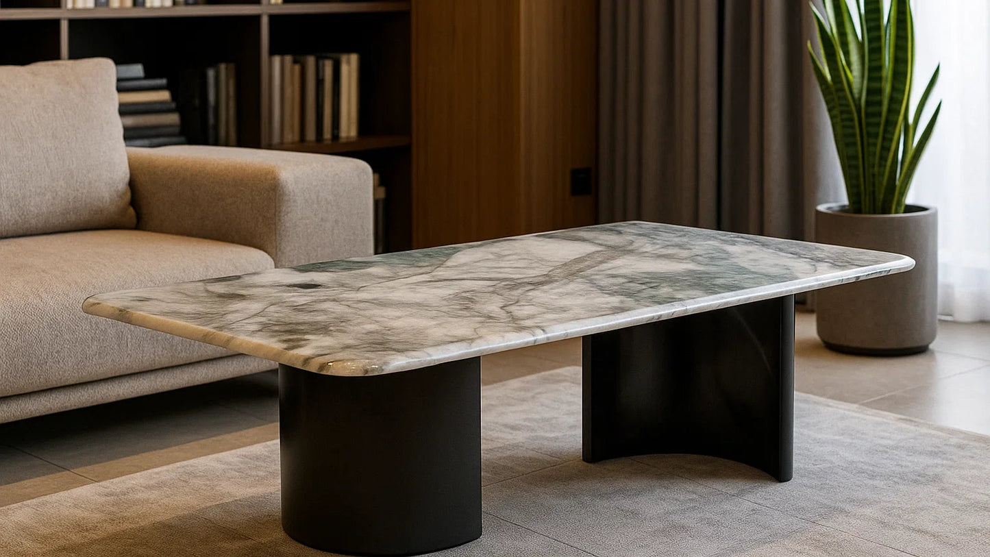 Modern coffee table with marble-like top and black cylindrical base in a living room setting.