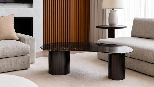 Modern living room with a dark wood coffee table and light-colored sofa.