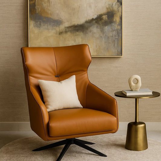 Brown leather armchair with a white pillow in a room with a gold side table and abstract painting.