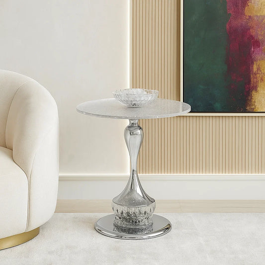Decorative glass side table in a stylish room with a sofa and abstract painting.